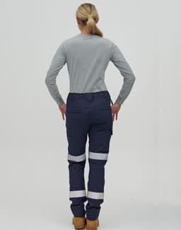 A pair of navy work pants with reflective tape, worn with a grey long-sleeve shirt, seen from the rear.