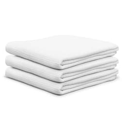 A stack of three white cotton cellular blankets, featuring a textured design.