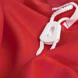 A red laundry bag made of 100% polyester, featuring a white drawstring and toggle for closure.