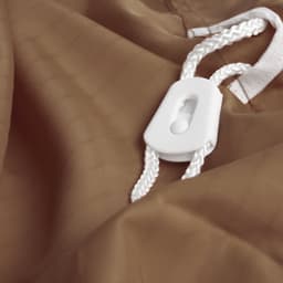 A brown laundry bag made of 100% polyester featuring a white drawstring and toggle.