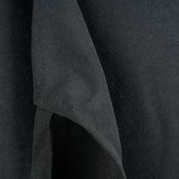 A close-up of a black apron bib, highlighting the fabric texture and stitching details.