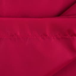 A red fabric close-up featuring a smooth texture with visible stitching. The material appears soft and vibrant.