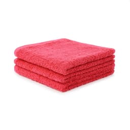 Three vibrant pink face washers stacked neatly together. The texture appears soft and fluffy, showcasing their quality.