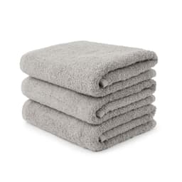 A stack of three folded small hand towels in a soft grey colour, featuring a plush texture.