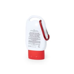 A white and red sunscreen bottle with a carabiner attached, featuring a detailed ingredient list on the back.