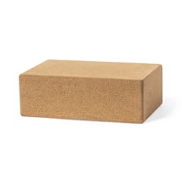 A rectangular cork yoga block in a natural beige colour, featuring a textured surface.