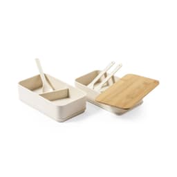 A light-coloured lunch box with a bamboo lid, featuring two compartments and three utensils. Includes a branding logo.