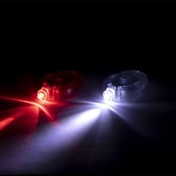 A red and a white light, both in circular cases, illuminated against a dark background. Each has a small logo.
