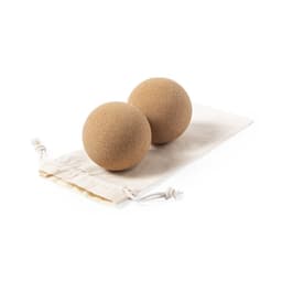 Two natural-coloured massage balls resting on a neutral drawstring pouch.