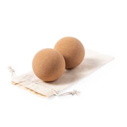 Two natural cork balls resting on a cream-coloured fabric pouch, designed for leisure and outdoor activities.