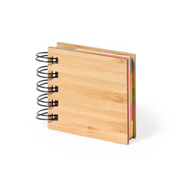 A wooden notebook with a spiral binding, featuring colourful sticky notes and flags inside.
