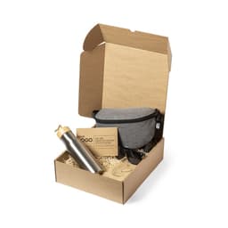 A gift box containing a grey pouch, silver drink bottle, sunglasses, and business cards, nestled in shredded paper.