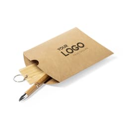 A brown paper envelope containing a bamboo pen and a keychain. The envelope features a logo.