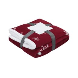 A folded red blanket featuring white snowflake patterns, tied with a grey ribbon. It has a branded label.