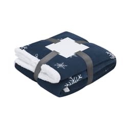 A navy blue blanket with snowflake patterns, featuring a soft white interior, neatly folded and secured with a strap.
