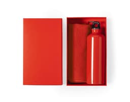 A red drink bottle and a red towel neatly packaged in a matching red box. The box has a logo on the interior.