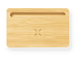 A bamboo organiser charger with a sleek design and a small groove for easy device placement.