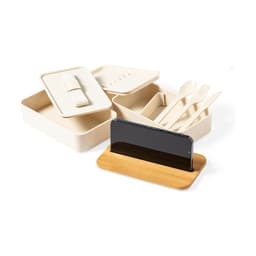 A cream lunch box set with compartments, utensils, and a bamboo phone stand. Includes a lid and a sleek design.