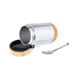 A stainless steel lunch container with a cork base, a bamboo lid, and a metal spoon beside it.