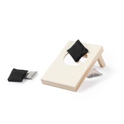A wooden bean bag toss game in light colour with two dark fabric bags nearby. The game features a circular hole for scoring.