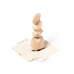 A wooden stacking puzzle featuring light-coloured geometric shapes on a canvas bag with a turtle design.