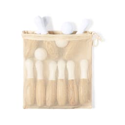 A mesh bag containing eight wooden game pieces with white caps, featuring a light, natural colour scheme.