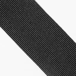 A close-up of a textured black fabric strap with a ribbed pattern, featuring a logo.