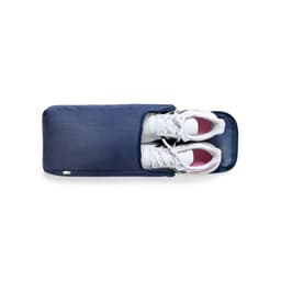 A navy Helanor Bag containing a pair of white sneakers with pink accents, featuring a logo.