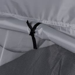 A close-up of a grey tent fabric with black ties and mesh detailing.