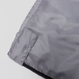 A grey bag with a smooth texture, featuring a zip closure and a small pocket on the side.