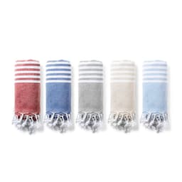 Five rolled bath towels in red, blue, grey, beige, and light blue, featuring striped patterns and fringed edges.