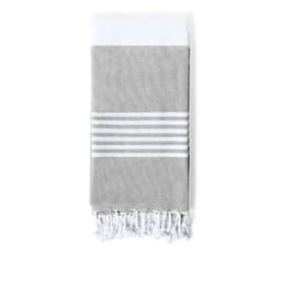 A grey bath towel with white stripes and fringed edges, featuring a logo or branding.