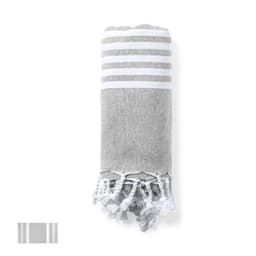 A rolled grey bath towel with white stripes and tasselled ends, featuring a logo on the side.