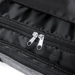 A wheeled bag featuring a grey exterior and black lining, with dual zippers for secure closure.