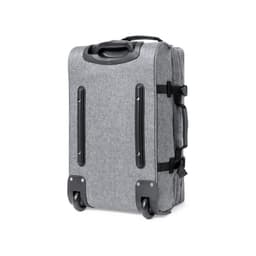 A grey wheeled bag with a textured fabric, featuring a handle and wheels for easy transport.