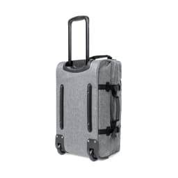 A wheeled bag in grey fabric with a retractable handle and side straps for easy carrying. It features a logo.