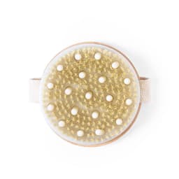 A round massage brush with a wooden base and soft bristles, featuring a beige strap for easy handling.