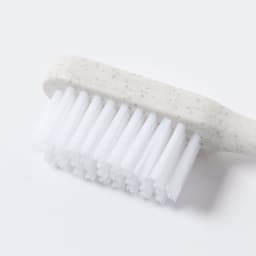 A health and personal care brush featuring a white and grey handle with soft bristles. The product has a simple, modern design.