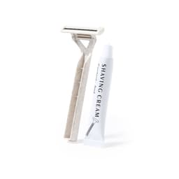 A shaving kit featuring a white razor and a tube of shaving cream. The items are neatly arranged and include a logo.