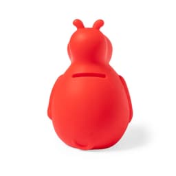 A red hippo-shaped money box made of silicone with a slot for coins at the top and a rounded body.