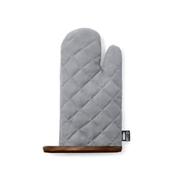 A grey quilted oven mitt with a brown leather trim and a label on the side.