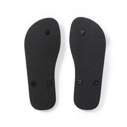 A pair of black thongs with textured soles, featuring two circular buttons on each.