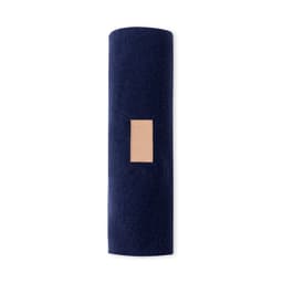 A rolled navy scarf with a tan leather patch, featuring a simple and elegant design.