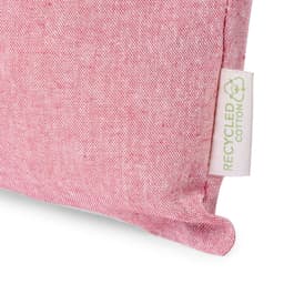 A close-up of a red folded bag made of recycled cotton, featuring a tag indicating recycled material.