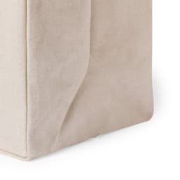 A neutral beige tote bag with a simple design and a visible brand logo on the side.