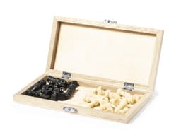 A wooden chess set with black and cream pieces housed in an open box, featuring a plain interior and a logo.