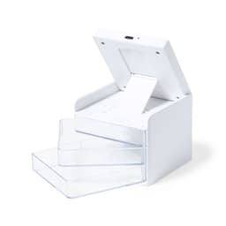 A white wireless charger with three transparent drawers, featuring a slot for device placement on top.
