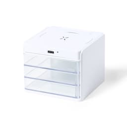 A white wireless charger features three clear drawers and a USB port, designed for phone and technology use.