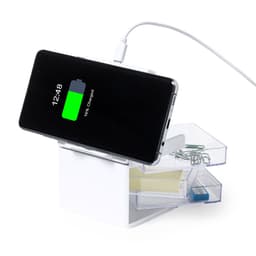 A white wireless charger with a phone displaying a battery charging indicator, featuring drawers for organisation.