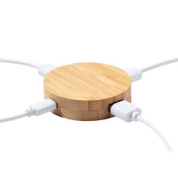 A round bamboo USB hub with multiple white cables connected to it. It features a simple, natural design.